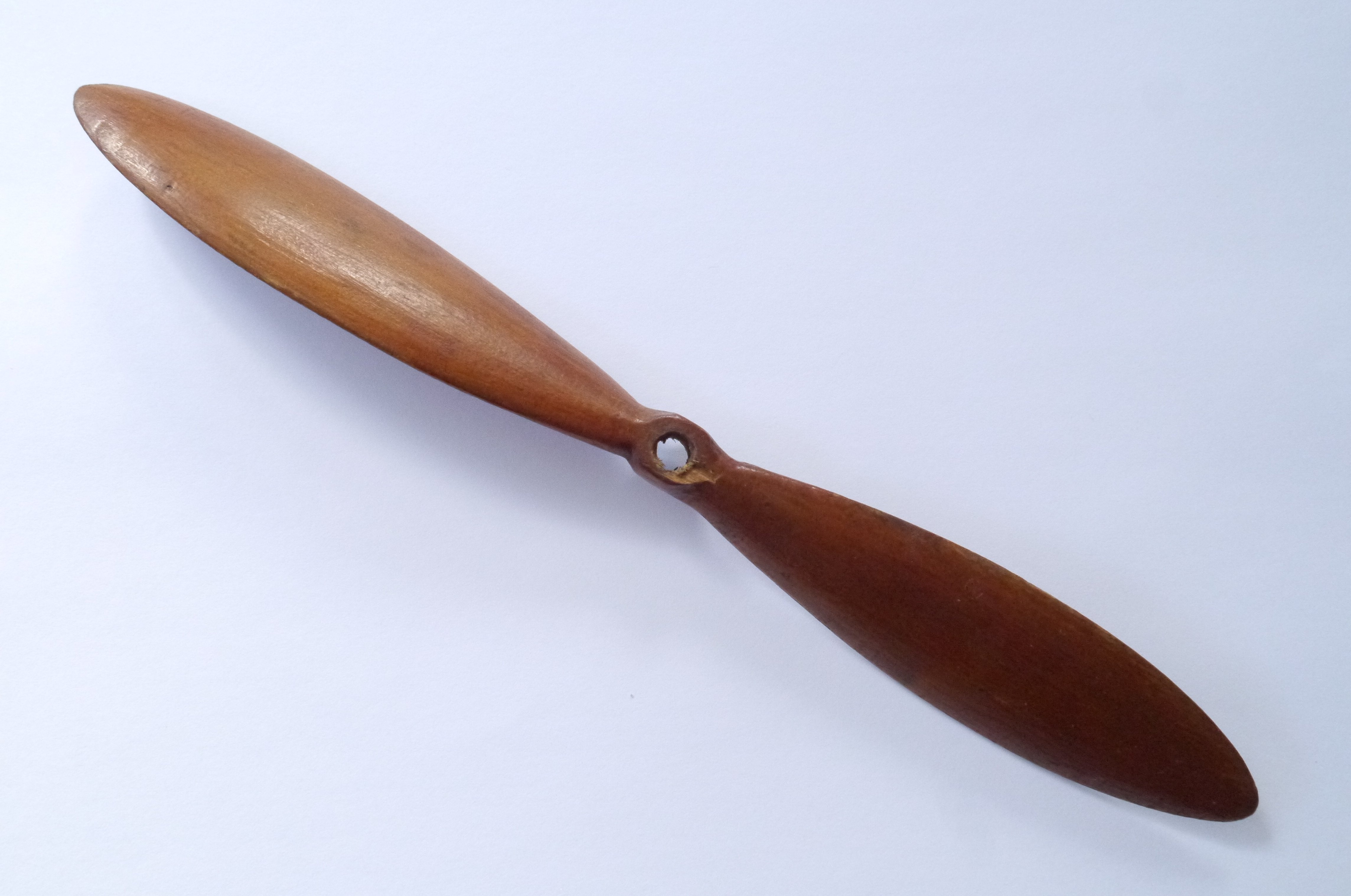 A wooden model aeroplane propeller hand carved by Clem. Length 252mm.